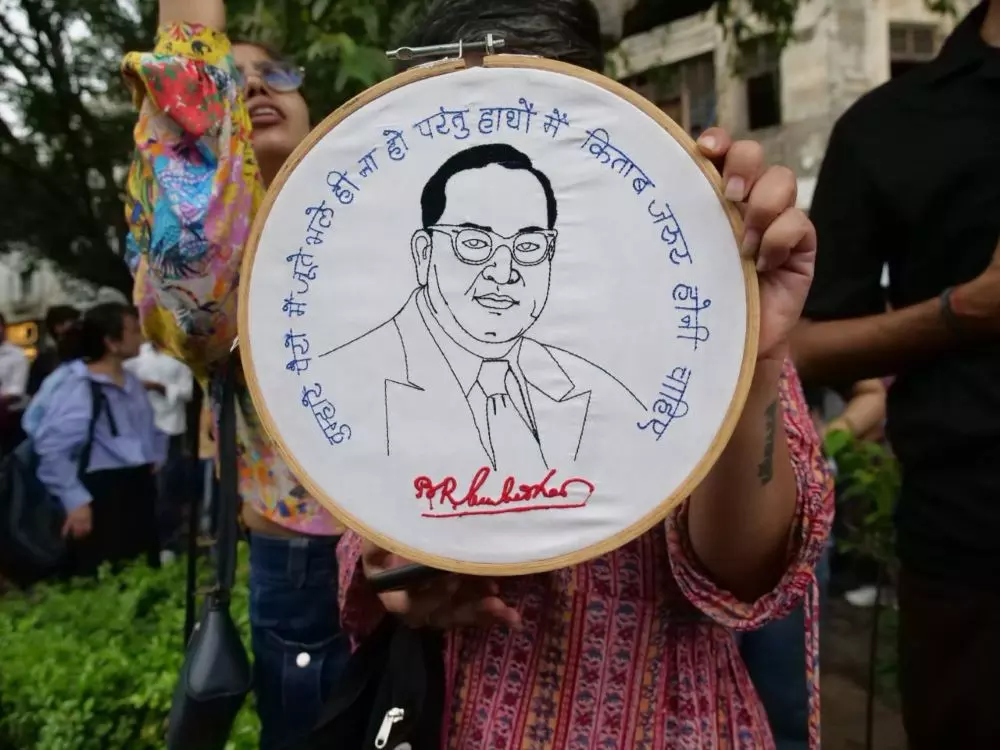 A protestor holds a sketch of BR Amedkar with his words extolling the importance of education. Photo: Eshan Sharma A protestor holds a sketch of BR Amedkar with his words extolling the importance of education. Photo: Eshan Sharma