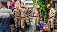 Rescue personnel carry out operations after a fire broke out at a private hotel in Tarapith, in Birbhum district