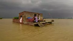 A house lies partially submerged in floodwaters following a rise in the water level of the Ganga river, at Nakta Diyara, in Patna