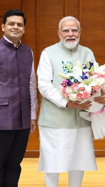 Dhanraj Nathwani (extreme left) with Prime Minister Narendra Modi and Parimal Nathwani Dhanraj Nathwani (extreme left) with Prime Minister Narendra Modi and Parimal Nathwani
