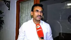 TVK Minister K.G. Arunraj speaking during an interview about the Dharapuram election campaign