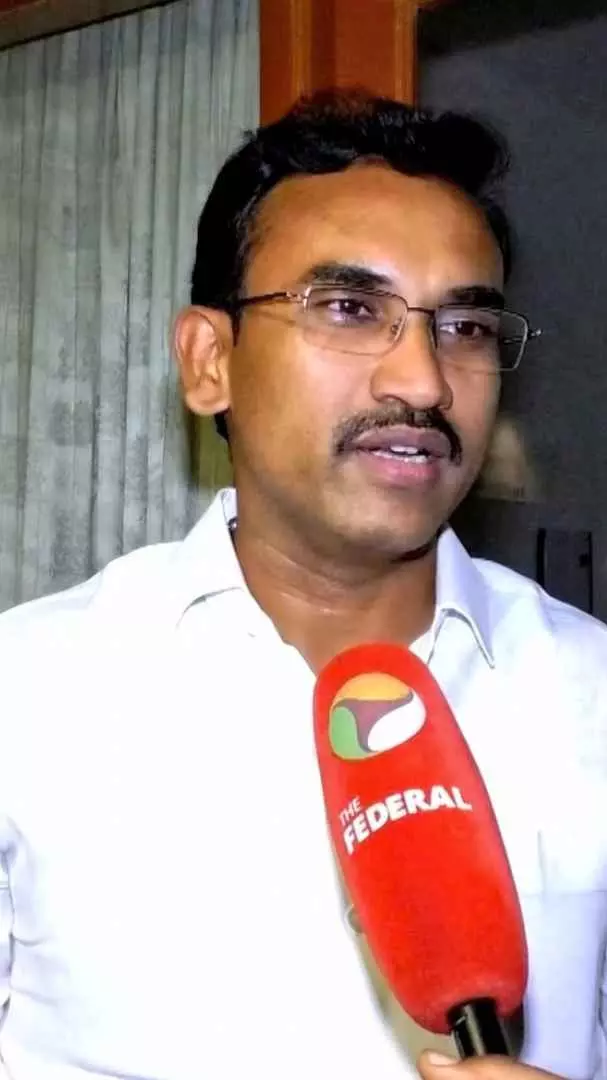 TVK Minister K.G. Arunraj speaking during an interview about the Dharapuram election campaign