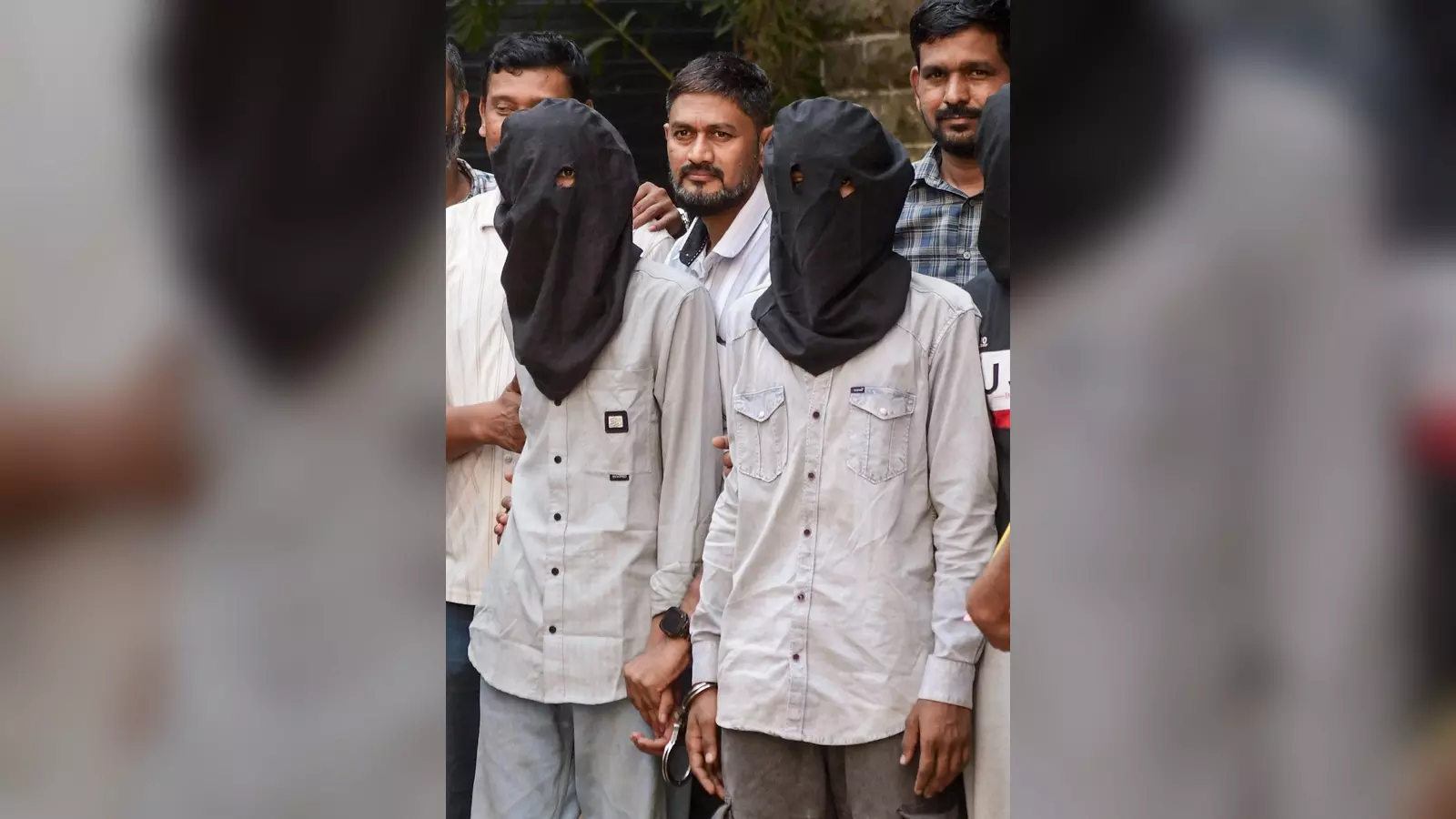 Accused persons, arrested for firing at actor Tiger Shroff on Sunday evening, being escorted by police Accused persons, arrested for firing at actor Tiger Shroff on Sunday evening, being escorted by police