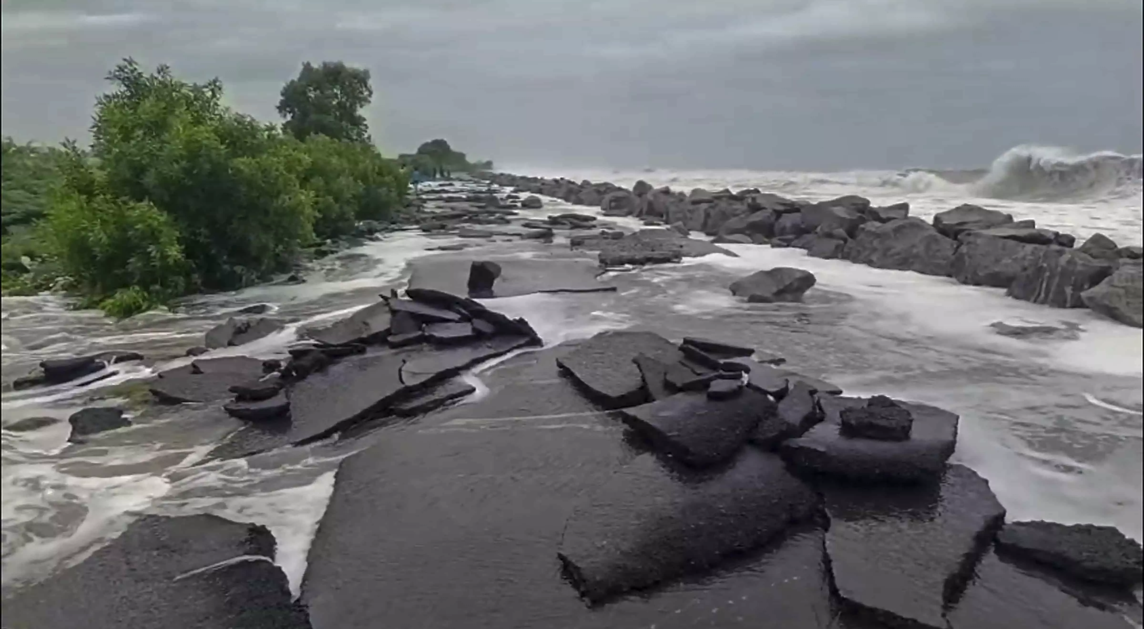 High tidal sea waves inundate and breach a coastal road ahead of cyclone High tidal sea waves inundate and breach a coastal road ahead of cyclone